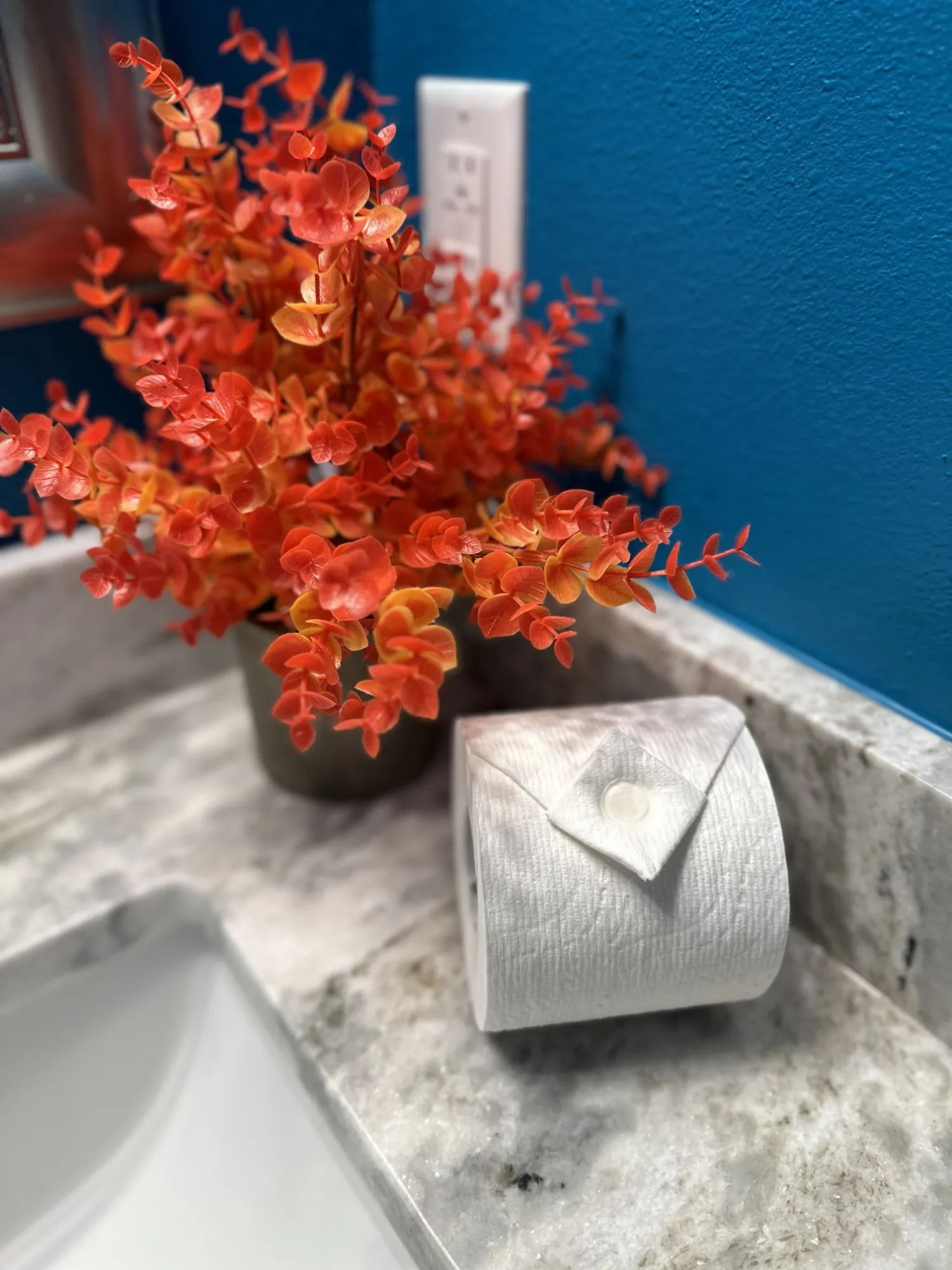 Toilet paper folded to a point on a bathroom vanity after a Brightside clean